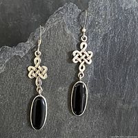 Full view of both sterling silver Celtic knot drop earrings with black onyx cabochons