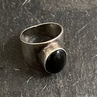 Side view of thick sterling band with bezel-set black onyx cabochon