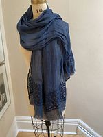 Full view of linen scarf draped on mannequin showing overall colour and drape