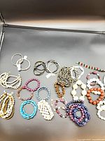 All bracelets laid out on black background