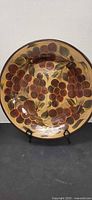 Front of round grape decor plate on stand