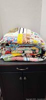 Folded multicolor patchwork quilt on cabinet