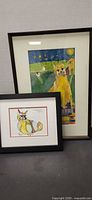 Both framed cat artworks front view