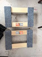 Top view of both wooden platform dollies showing carpet pads