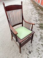 Full view of walnut library chair, showing spindle back, arms and green seat