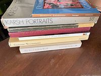 Stack of seven books showing spines including Karsh Portraits, Mother, Ceramic Techniques, The Art of Andrew Wyeth