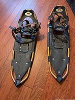 Full view of both Atlas snowshoes showing frames, decking, bindings