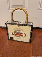 Front view showing Bueno label artwork, latch and bamboo handle