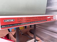 Close-up of Lifetime branding and product label on table edge