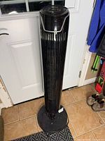 Full view of black NOMA tower fan on base