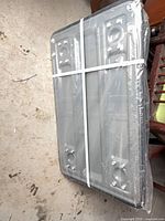 Cart underside showing four mounting plates, wrapped