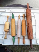 Five rolling pins laid out showing sizes and materials