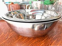 Side view of nested stainless steel mixing bowls