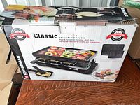 Retail box showing Swissmar Classic 8-person raclette grill