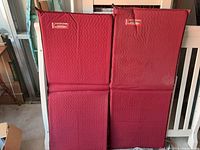 Front view of two red Therm-a-Rest pads standing side by side