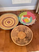 Top view of three woven baskets showing patterns and colours