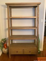 Full front view of grey driftwood bookcase showing shelves and drawers