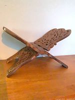 Book stand opened in X position showing carved panels