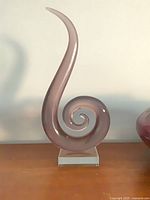 Front view of spiral glass sculpture on base