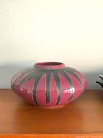 Side view showing burgundy body with black drip glaze pattern