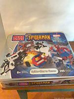 Front of Mega Bloks Spider-Man vs Venom tin showing artwork, age rating 6+, 280-piece count