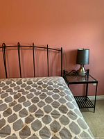 Headboard and nightstand beside bed