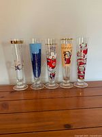 Five Ritzenhoff pilsner glasses with varied artist graphics displayed side by side