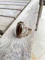 Front view of ring showing tiger’s eye stone and filigree setting