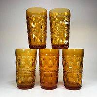 Front view of five amber King’s Crown tumblers arranged 3-2