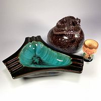 Front view of all three items showing ashtray glaze, trinket box with lizard, wooden egg cup figure