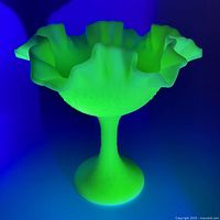 Compote glowing bright green under UV light highlighting uranium content