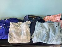 All six folded tops displayed side by side