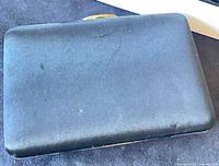 Black satin hard-sided clutch closed view