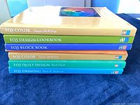 Stack of six EQ5 books showing spines and authors