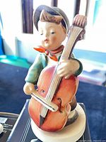 Close-up of Hum 560 boy playing cello figurine