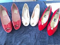 Three pairs of vintage heels on table