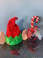 Elf hat and candy cane headbands side by side
