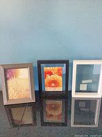 Three frames—wood-tone 6x8, black 5x7, white 4x6—front view