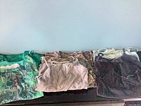 All eight camisoles and tank tops folded in a row