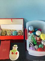 Overview of boxed eggs, Lenox dish and tub of loose ornaments