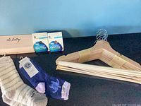 Overview of hangers, socks, pantyhose, heel insert box on tabletop