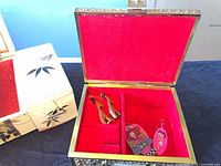 Interior of first trinket box showing red felt lining and removable divided tray