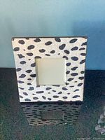 Front view of cream and black spotted picture frame showing pattern and 4x6 opening