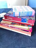 Stack of seven quilting and craft books