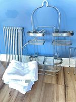 All items together: shower caddy, roll-up mat, stack of white towels