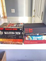 Two stacks of nine Stephen King hardcovers on ledge