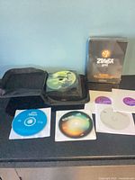 Group shot showing sealed Zumba Gold box, open CD wallet, four loose CDs