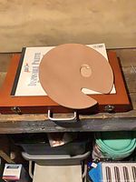 Closed wood case with sketch pad and palette on top