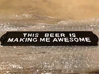 Front of metal sign displaying text