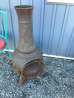 Full view of chiminea showing chimney, body, legs, and door